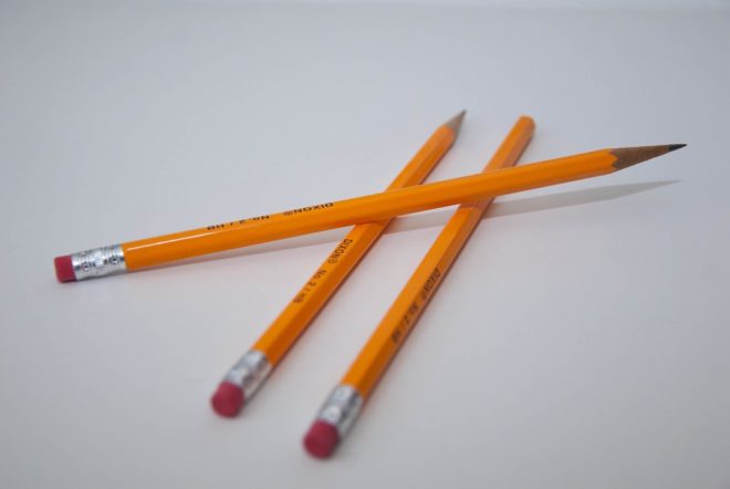 three yellow pencils on a whitish gray background